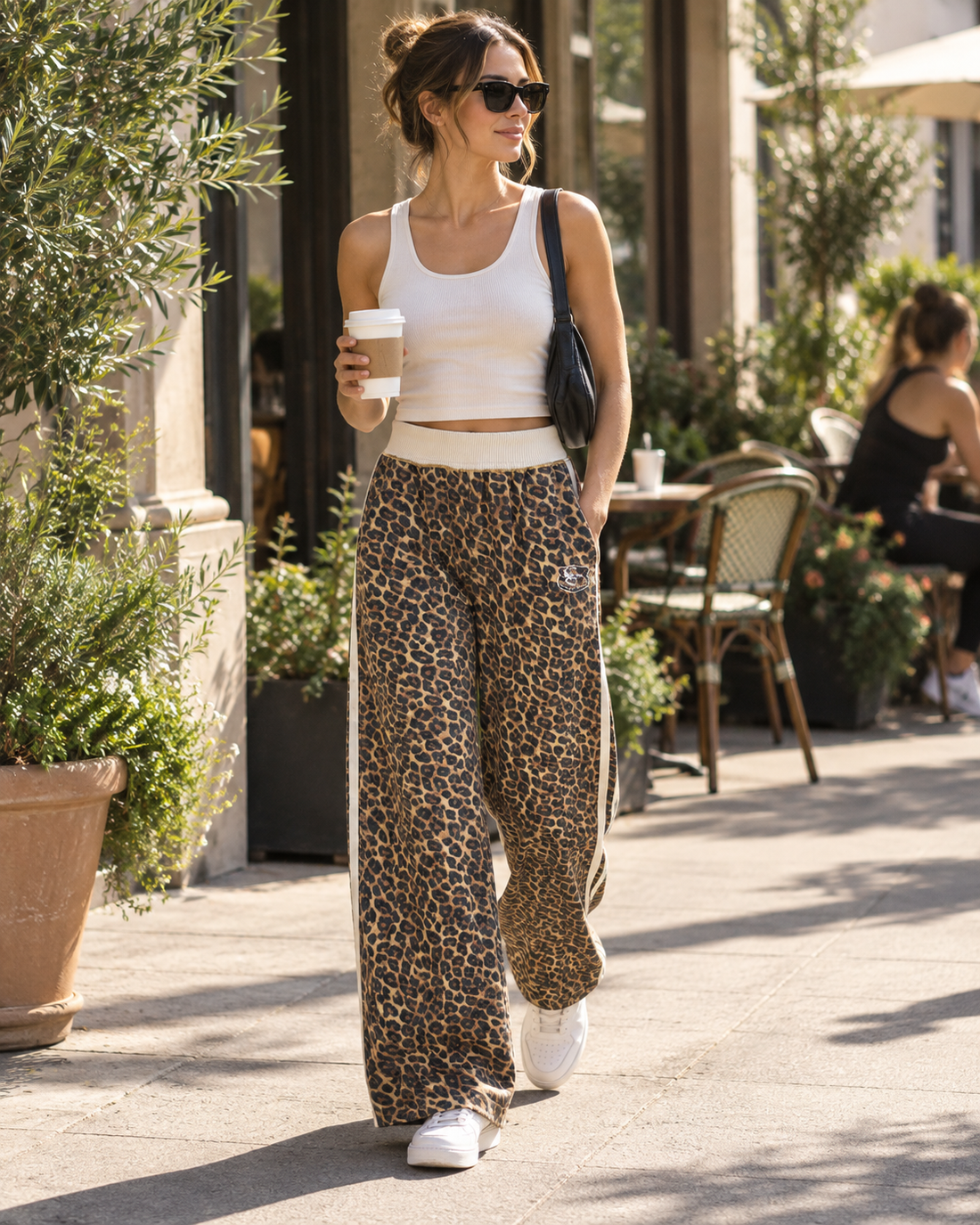 Red Monté leopard patchwork sweatpants styled with a clean white tank for a Pilates coffee run