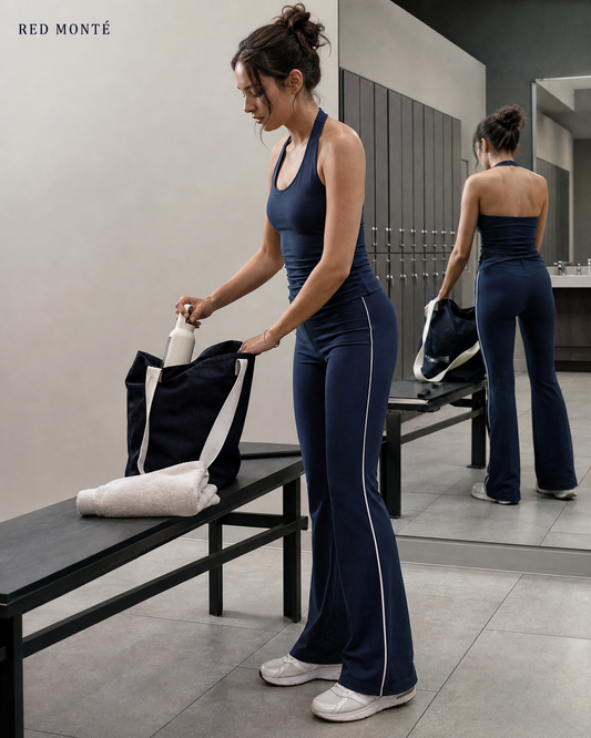 Red Monté navy side-stripe flare yoga pants styled in a locker-room mirror setting