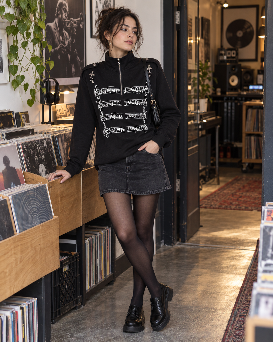 Red Monté black music-staff graphic half-zip tee styled with dark skirt and chunky shoes in a record store