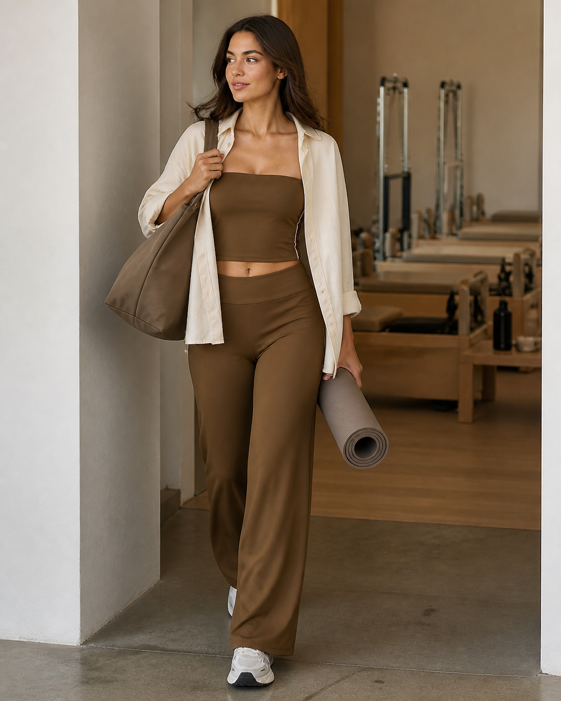 Red Monté chestnut straight wide-leg yoga pants styled with an open cream shirt while leaving a Pilates studio