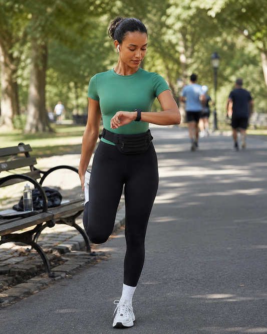 Red Monté gem green short-sleeve active top styled with black leggings on a city park running path