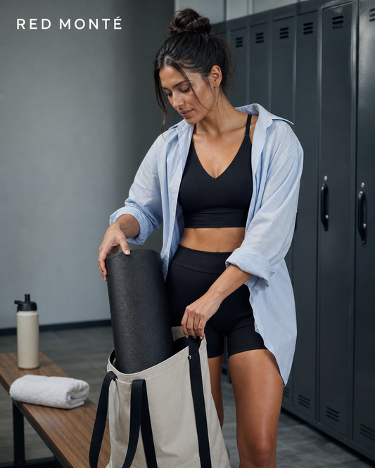 Red Monté premium black V-neck active top styled with high-waisted shorts and an open pale blue shirt