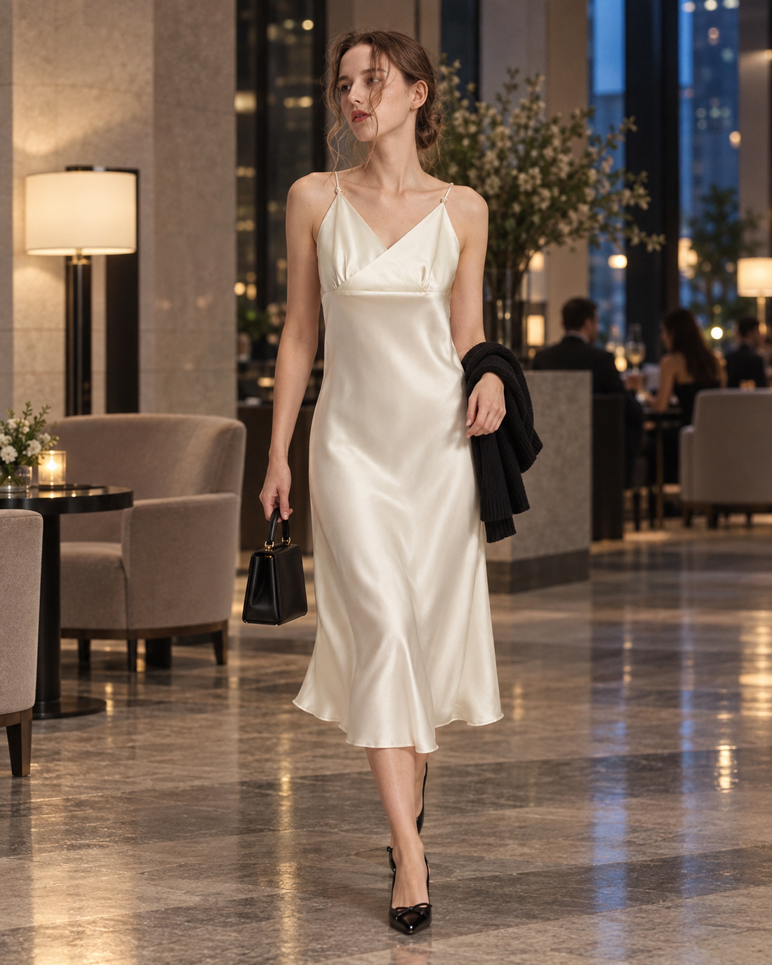 Red Monté ivory cross-front silk cami dress styled with black accessories for city dinner